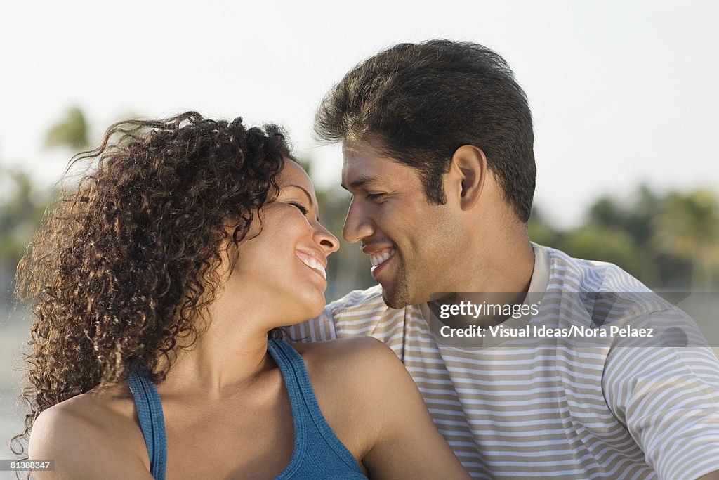 Hispanic couple smiling at each other