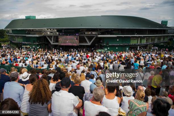 Spectators watch the action on the screen from 'Murray Mound' during the Ladies Singles semi final match between Johanna Konta of Great Britain and...