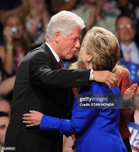 Democratic presidential hopeful and New York Senator Hillary Rodham Clinton gets a hug from husband former US President Bill Clinton during her...