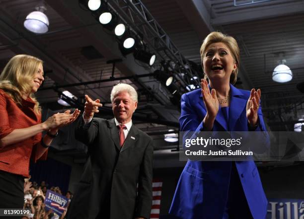 Chelsea Clinton, former U.S. President Bill Clinton and Democratic presidential hopeful Hillary Clinton greet supporters as she arrives at her final...