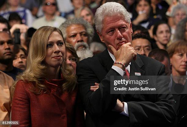 Chelsea Clinton and former U.S. President Bill Clinton look on Democratic presidential hopeful Hillary Clinton speaks to supporters at the final...