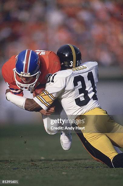 Football: AFC Playoffs, Denver Broncos Steve Watson in action during tackle vs Pittsburgh Steelers Donnie Shell , Denver, CO