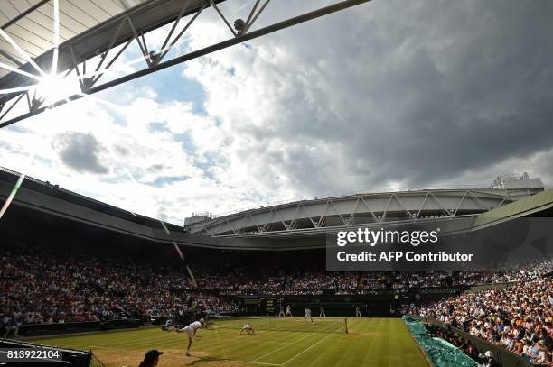 Britain's Jamie Murray and Switzerland's Martina Hingis serve against Britain's Ken Skupski and Britain's Jocelyn Rae during their mixed doubles...