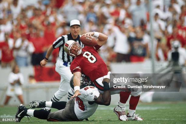 Football: San Francisco 49ers QB Steve Young in action during sack vs Tampa Bay Buccaneers Warren Sapp , Cover, Tampa, FL 8/31/1997
