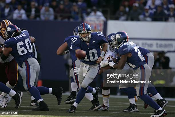 Football: New York Giants QB Eli Manning in action, making handoff to Tiki Barber vs Washington Redskins, East Rutherford, NJ