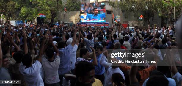 Residents of Dadar celebrates the wicket of Sri lankan batsmen in Shivaji Park as they enjoy World Cup final match between India and Sri Lanka on the...