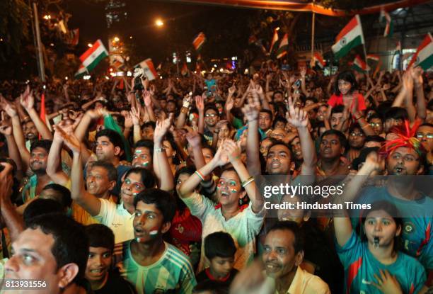 Residents of Dadar celebrates after wining the world cup in Shvaji Park as they enjoy World Cup final match between India and Sri Lanka on the giant...