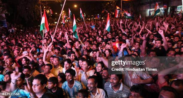 Residents of Dadar celebrates after wining the world cup in Shvaji Park as they enjoy World Cup final match between India and Sri Lanka on the giant...