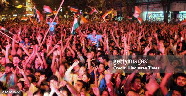 Residents of Dadar celebrates after wining the world cup in Shvaji Park as they enjoy World Cup final match between India and Sri Lanka on the giant...