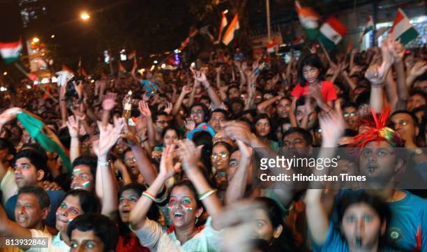 Residents of Dadar celebrates after wining the world cup in Shvaji Park as they enjoy World Cup final match between India and Sri Lanka on the giant...