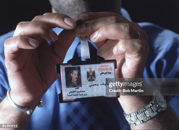 Politics: Closeup portrait of Uday Hussein's body double Latif Yahia with ID card, London, GBR 3/14/2003