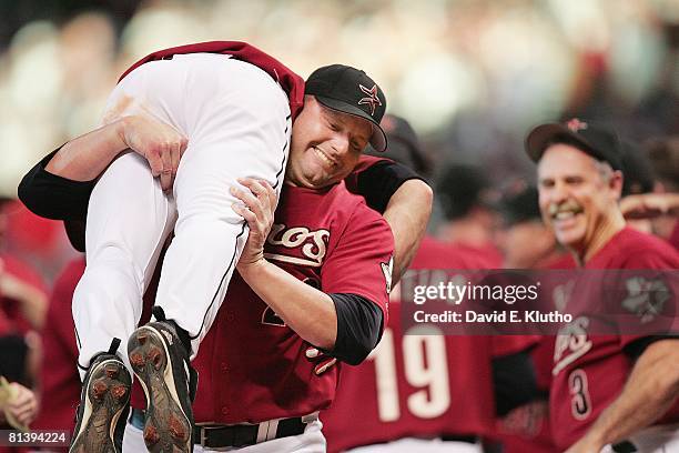 Baseball: NLDS Playoffs, Houston Astros Roger Clemens victorious, picking up Chris Burke after hitting game winning, solo home run vs Atlanta Braves,...