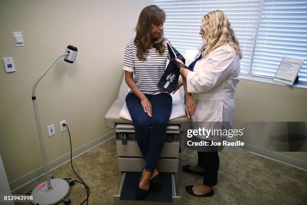 Ginger Rae has her blood pressure checked by registered nurse practitioner Rachel Eisenberg during a checkup at a Planned Parenthood health center on...