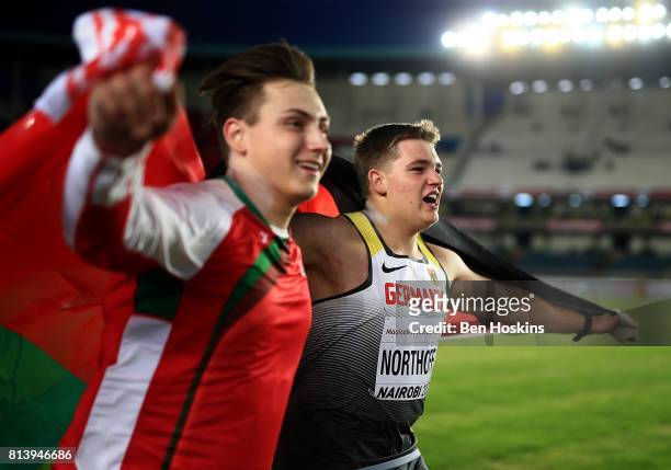 Shot put silver medalist Mikhail Samuseu of Belarus and gold medalist Timo Northoff of Germany celebrate following the final of the boys shot put on...