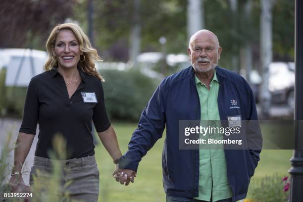 Pete Karmanos, co-owner and chief executive officer of the Carolina Hurricanes, right, arrives with his wife Danielle Karmanos for the morning...