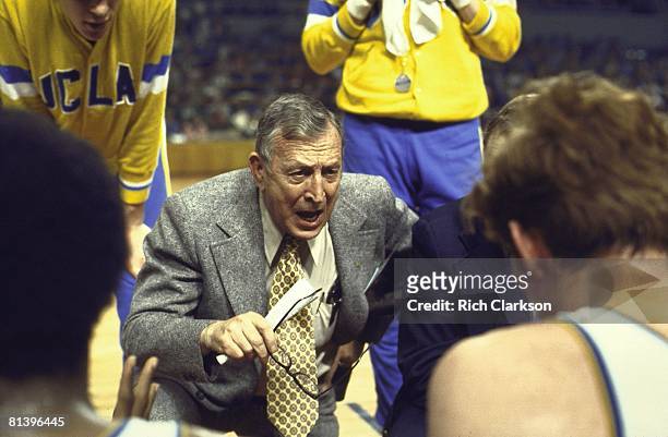 College Basketball: NCAA playoffs, UCLA coach John Wooden in huddle with team during timeout, Los Angeles, CA 3/23/1972