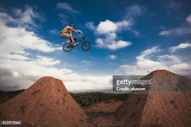 bmx cyclist jumping high. real jump. - sports ramp stock pictures, royalty-free photos & images