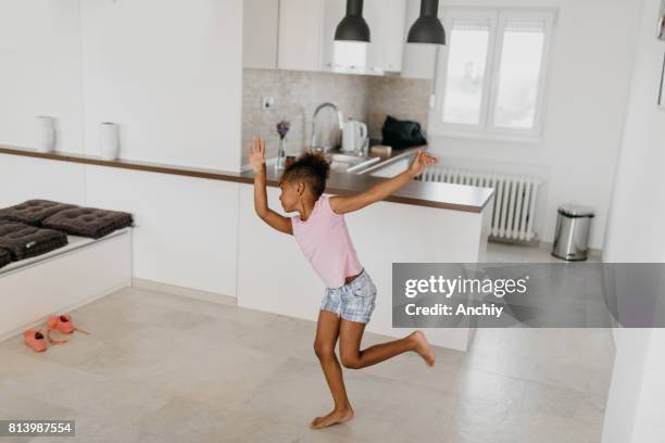 beautiful african ethnicity kid is dancing in front of the mirror - cartwheel stock pictures, royalty-free photos & images