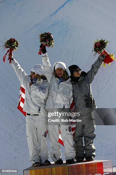 Snowboarding: 2006 Winter Olympics, USA Gretchen Bleiler , USA Hannah Teter , and Norway Kjersti Buaas victorious on medal stand with flag after...