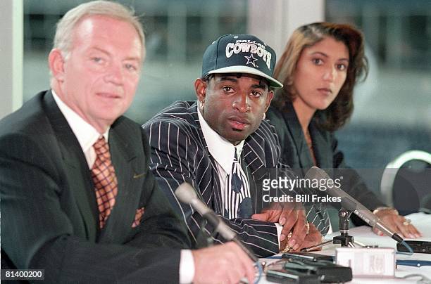 Football: Dallas Cowboys owner Jerry Jones with Deion Sanders and his wife during media press conference announcing signing to team, Dallas, TX...