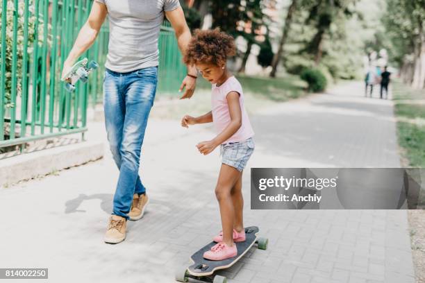 i'm doing it all by myself daddy - father longboard stock pictures, royalty-free photos & images