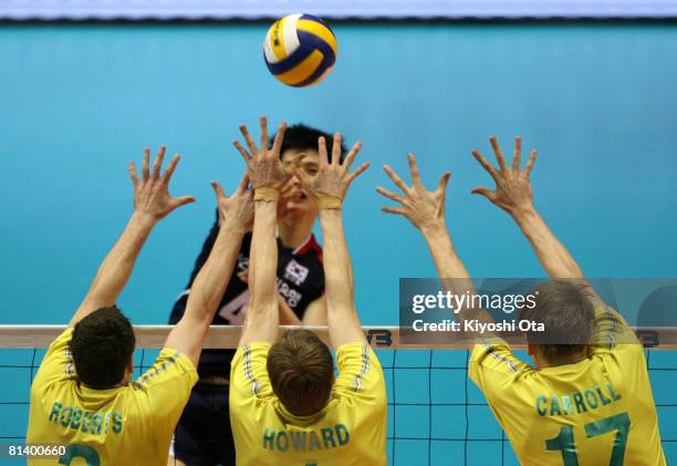 Nathan Roberts, Dainel Howard and Paul Carroll of Australia jump to block the ball against South Korea during the FIVB Men's World Olympic...