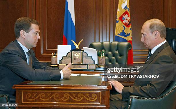 Russian President Dmitry Medvedev speaks with Prime Minister Vladimir Putin at the presidential residence outside Moscow in Gorki on June 4, 2008....