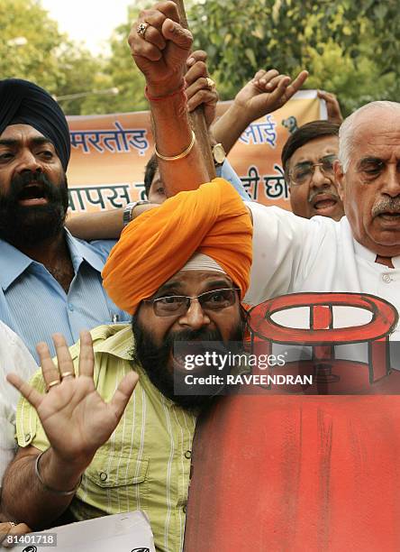 Activists from National Akali Dal shout anti-government and Prime Minister Manmohan Singh slogans during a protest against the government increase in...