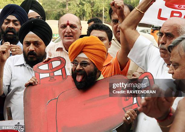 Activists from National Akali Dal shout anti-government and Prime Minister Manmohan Singh slogans during a protest against the government increase in...