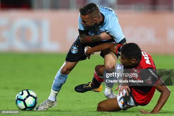 Marcio Araujo of Flamengo struggles for the ball with Luan of Gremio during a match between Flamengo and Gremio as part of Brasileirao Series A 2017...