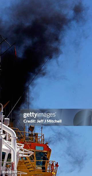 Fumes pour from a ship docked in Aberdeen harbour, June 4, 2008 in Aberdeen, Scotland. Recent rises in oil prices is bringing more financial wealth...