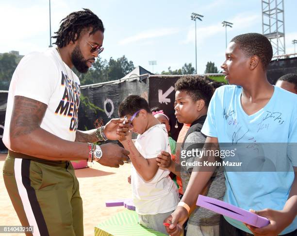 Player DeAndre Jordan signs autographs at Nickelodeon Kids' Choice Sports Awards 2017 at Pauley Pavilion on July 13, 2017 in Los Angeles, California.