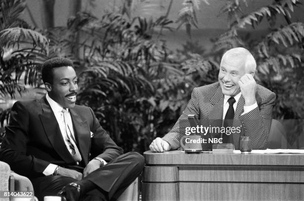 Pictured: Talk show host Arsenio Hall during an interview with host Johnny Carson on July 21, 1988 --