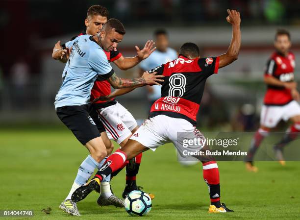 Marcio Araujo and Gustavo Cuellar of Flamengo struggle for the ball with Luan of Gremio during a match between Flamengo and Gremio as part of...