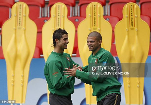 Portuguese forward Cristiano Ronaldo jokes with defender Pepe during a training session in Neuchatel on June 04 ahead of the Euro 2008 Football...
