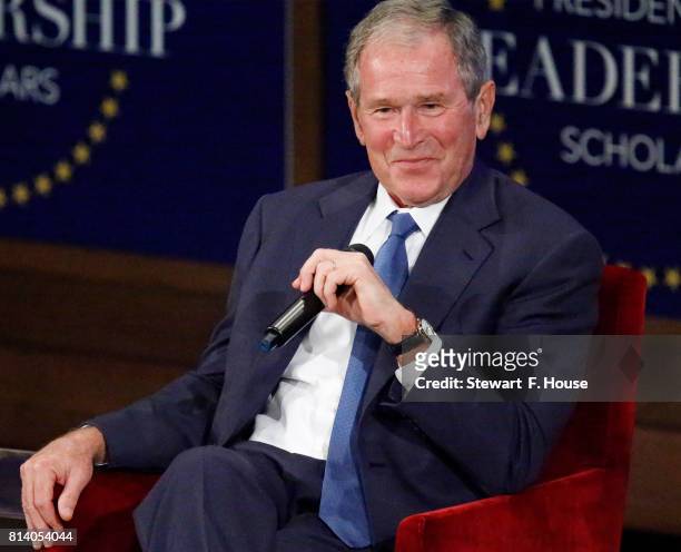 Former U.S. President George W. Bush responds with a smile after making a joke while answering a question at the Presidential Leadership Scholars...
