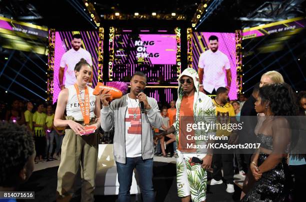 Host Russell Wilson accepts the King of Swag award from WNBA player Breanna Stewart, TV personality Nick Cannon, MLB player Prince Fielder, NHL...