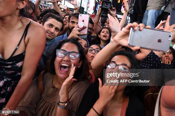 Fans cheer as Bollywood movie stars perfom on stage during the IIFA Stomp in Times Square on July 13, 2017 to kick off the 18th International Indian...