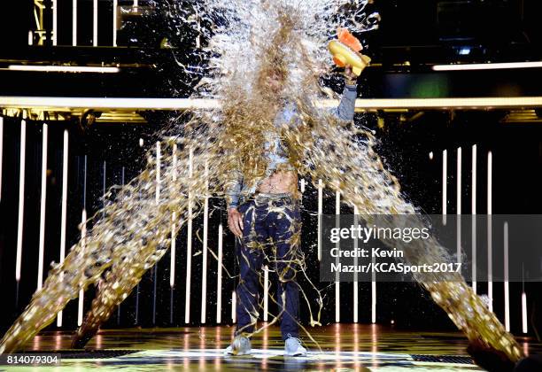 Honoree Michael Phelps gets slimed while accepting the Legend Award onstage during Nickelodeon Kids' Choice Sports Awards 2017 at Pauley Pavilion on...