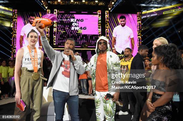 Host Russell Wilson accepts the King of Swag award from WNBA player Breanna Stewart, TV personality Nick Cannon, MLB player Prince Fielder, NHL...