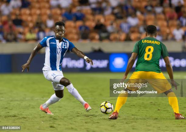 Honduras forward Alberth Elis sends the ball past French Guiana defender Jean-David Legrand during the CONCACAF Gold Cup Group A match between...