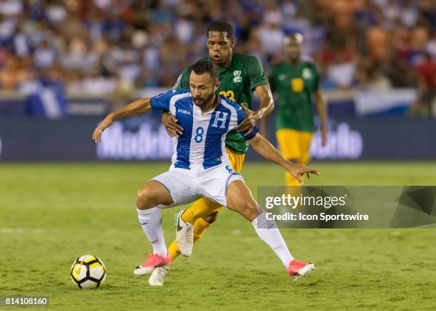 Honduras midfielder Alfredo Mejia keeps the ball away from French Guiana midfielder Ludovic Baal during the CONCACAF Gold Cup Group A match between...