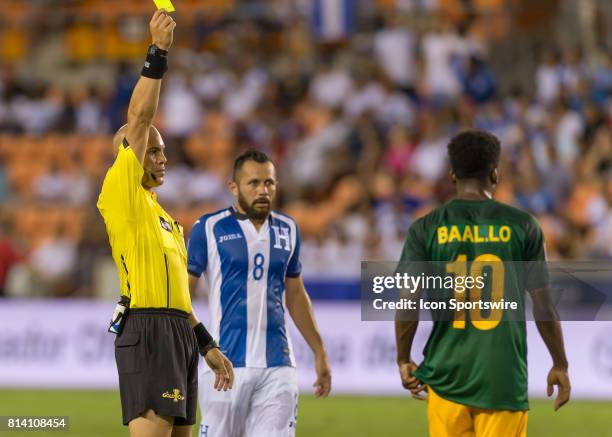 Referee issues a yellow card to French Guiana midfielder Loïc Baal during the CONCACAF Gold Cup Group A match between Honduras and French Guiana on...