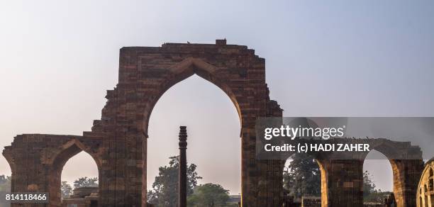 iron pillar of delhi | qutub complex | unesco world heritage site - iron pillar new delhi stock pictures, royalty-free photos & images