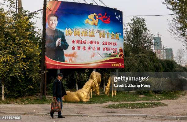 Huge propaganda poster stands at roadside, on which President Xi is calling people to deepen reform and enforce legislation.