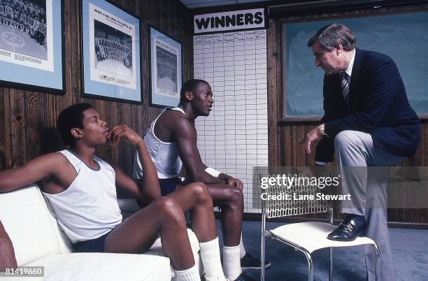 College Basketball: Portrait of North Carolina Sam Perkins , Michael Jordan , and coach Dean Smith in office at University of North Carolina, Chapel...