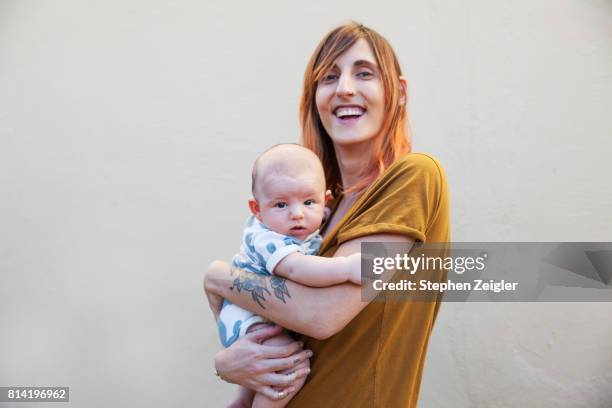 a mother holding her newborn baby - mother holding baby white background stock pictures, royalty-free photos & images