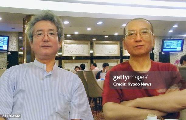 Photo taken on July 30 shows Chinese dissident Liu Xiaobo and his interviewer Yasuhiro Mori of Kyodo News at a restaurant in Beijing. Liu, who won...