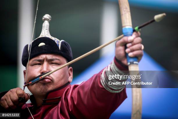 Man attends the traditional Nadaam festival in Ulan Bator on July 12, 2017. The festivities consist of a number of national ceremonies, concerts, and...