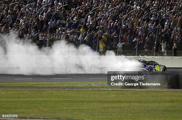 Auto Racing: NASCAR Coca Cola 600, Jimmie Johnson in action, spinning victorious donuts at finish line after winning race, Concord, NC 5/29/2005